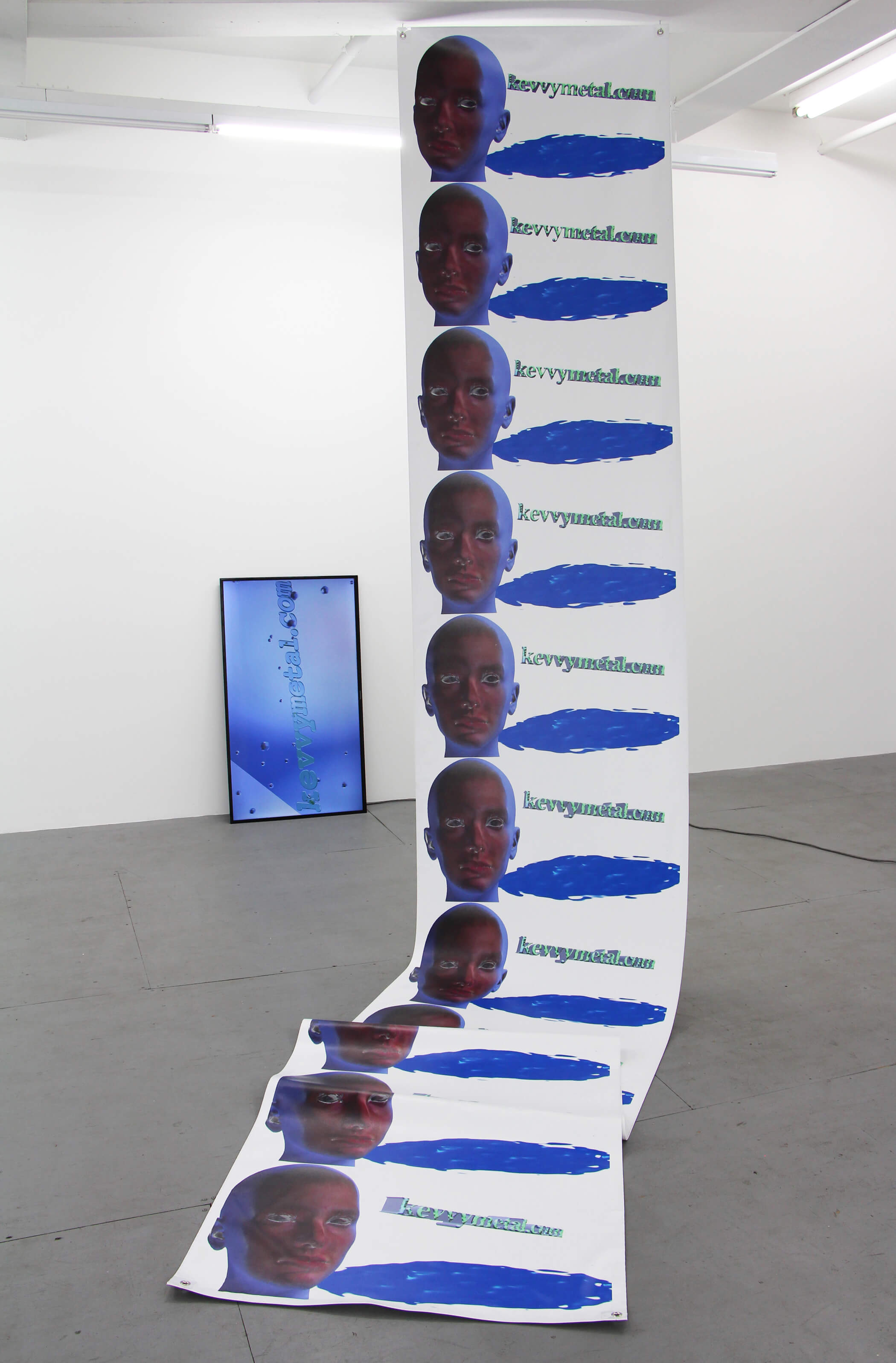Kevin Reuning, "kevvymetal.com" and "kevvymetal.com (GIF I)", 2015, single-channel HD video, archival ink on vinyl (228 x 36 inches), installation view