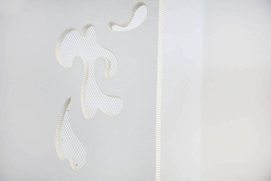 A wood partition is depicted. abstract cut outs that look like abstracted semen are cut out of the thin wood partition. The cut outs are embroidered with a white lace mesh.