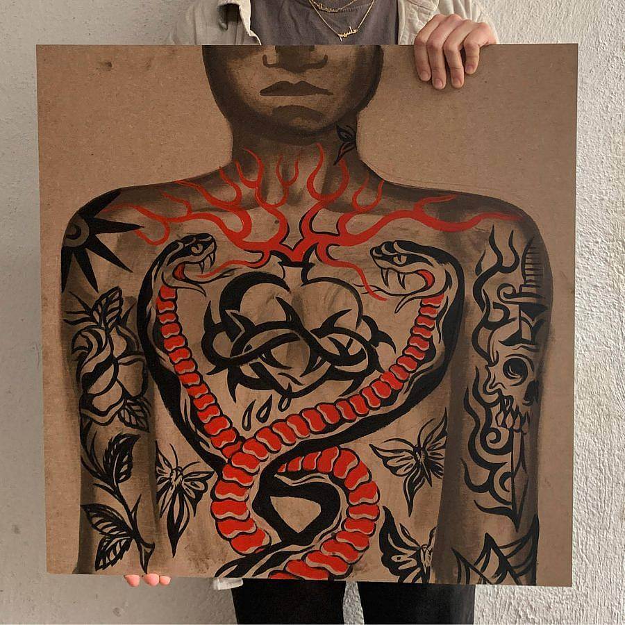 A person holds up a painting. The painting uses latex paint on masonite. It features a tattooed person. The chest has a heart tattooed on it, with thorns encircling it, red flame line work extends outside it. Two snakes encircle the heart. Other tattoos of skulls and butterflies are on the person's arms. 