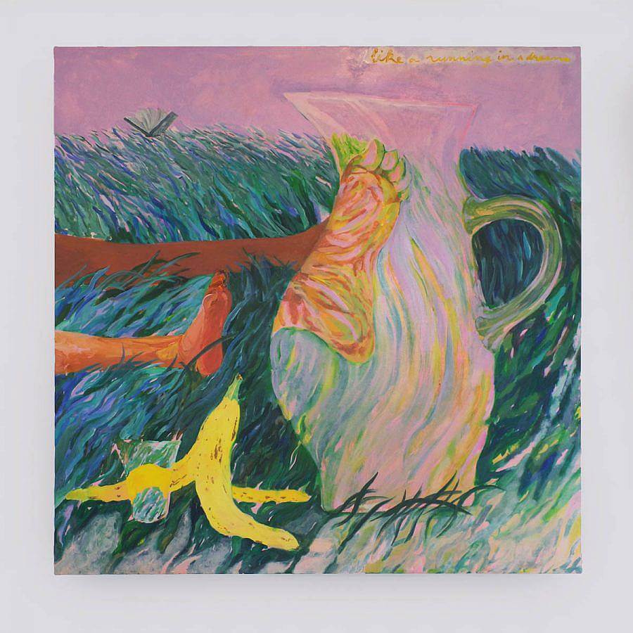 A banana peel and water pitcher sit on a grassy landscape. Behind the pitcher are a figures feet lying in the grass. The. sky is a soft pink, the grass of blues and greens. The figures foot becomes magnified behind the water pitcher.