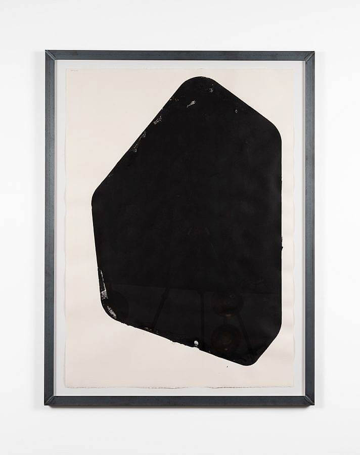 Image Description: A black block-printed shape with six sides on white paper in a welded metal frame. 