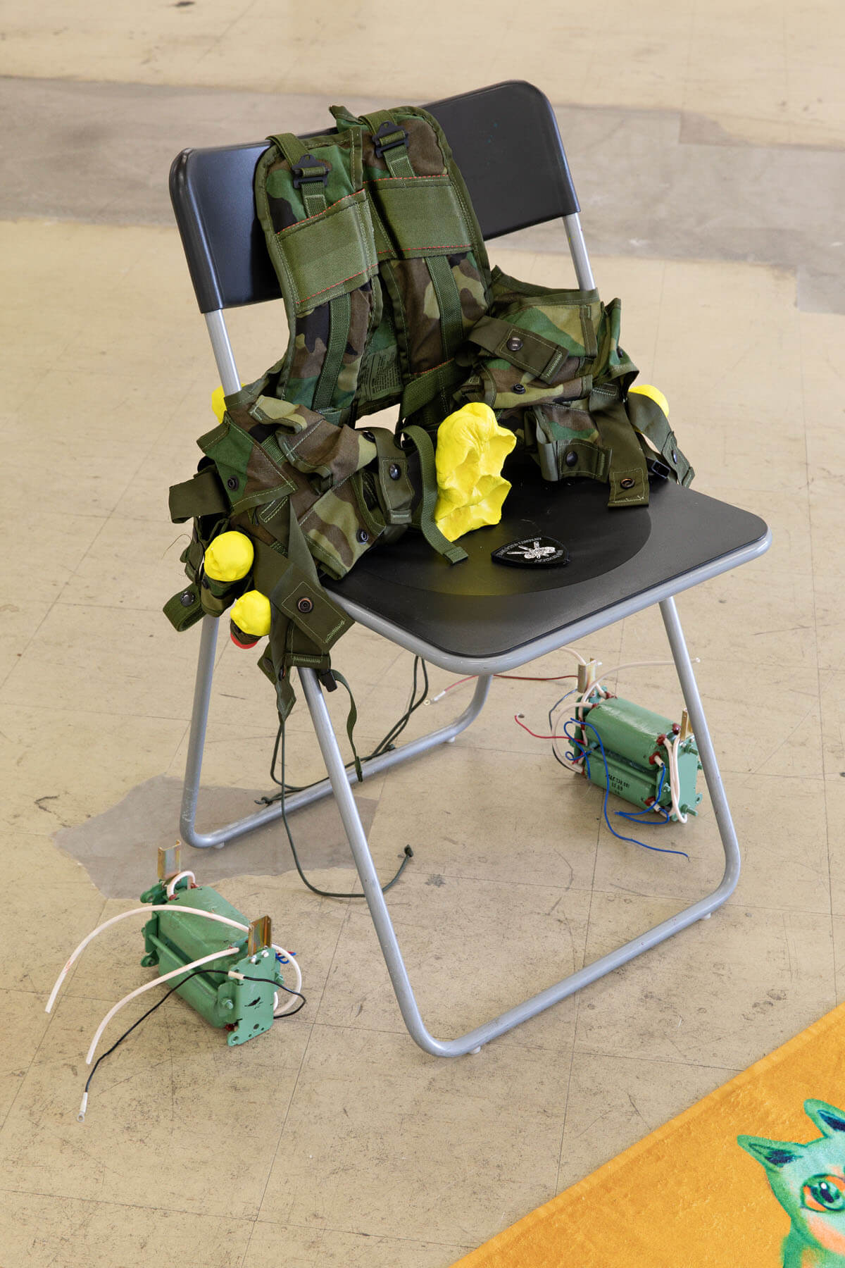 A picture of a combat vest in a folding chair, from Ville Kallio's 2019 show "Venmo Combat" 