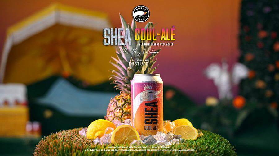 Image Description: This is a still of a beer can sitting on an astro turf stool with a pineapple and several lemons. Their is a goose wearing a crown on the can and the name Shea Coul-Alé with the company logo is at the top of the shot.